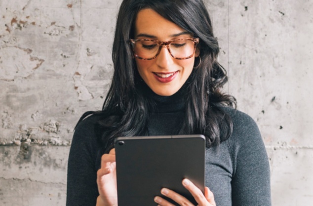 Woman uses Suzuki Finance Calculator on a tablet