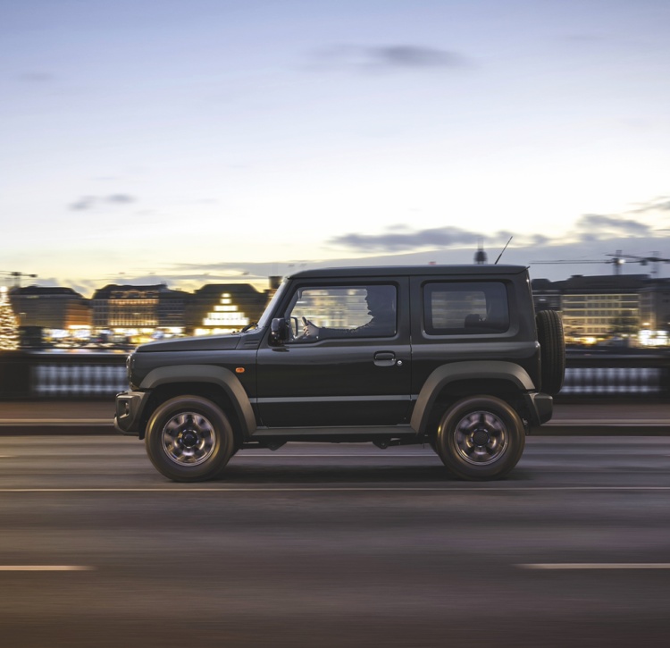 Black Jimny driving on city road