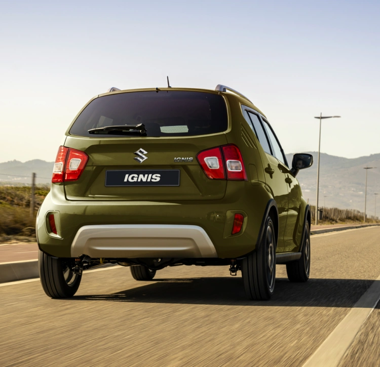 Khaki green Suzuki Ignis rear on road