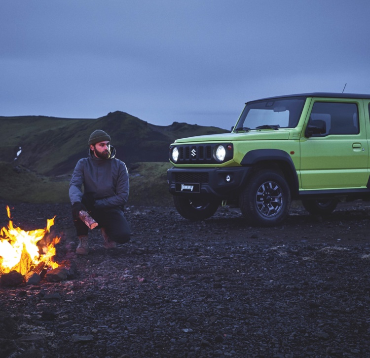 Man camping in wild near Jimny